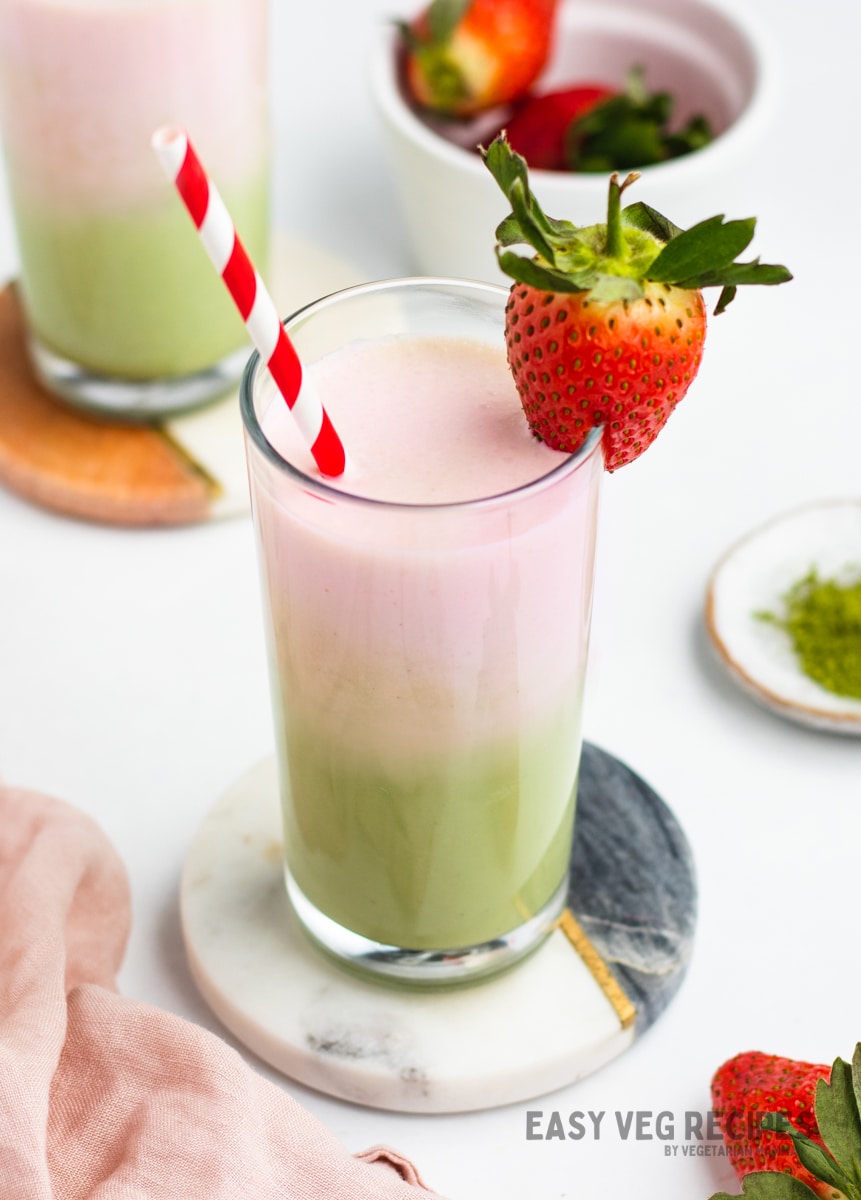 A matcha latte topped with strawberry cream and fresh berries. 