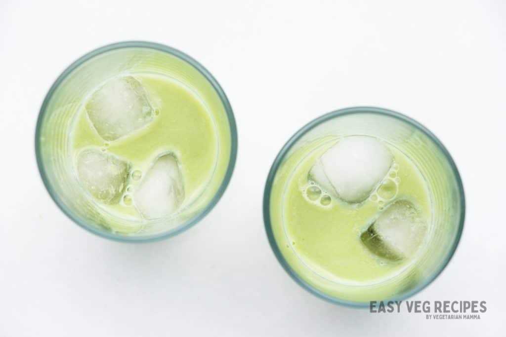 matcha milk in glasses filled halfway.