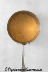 Once the syrup reaches the hard crack stage, remove the saucepan from heat. Quickly add the butter, vanilla extract, and baking soda. Stir to combine.