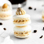 two coffee macarons stacked on top of each other.