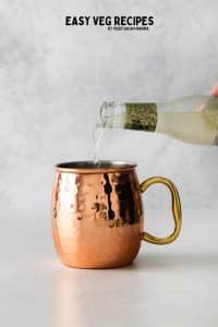 Ginger beer pouring into a london mule.