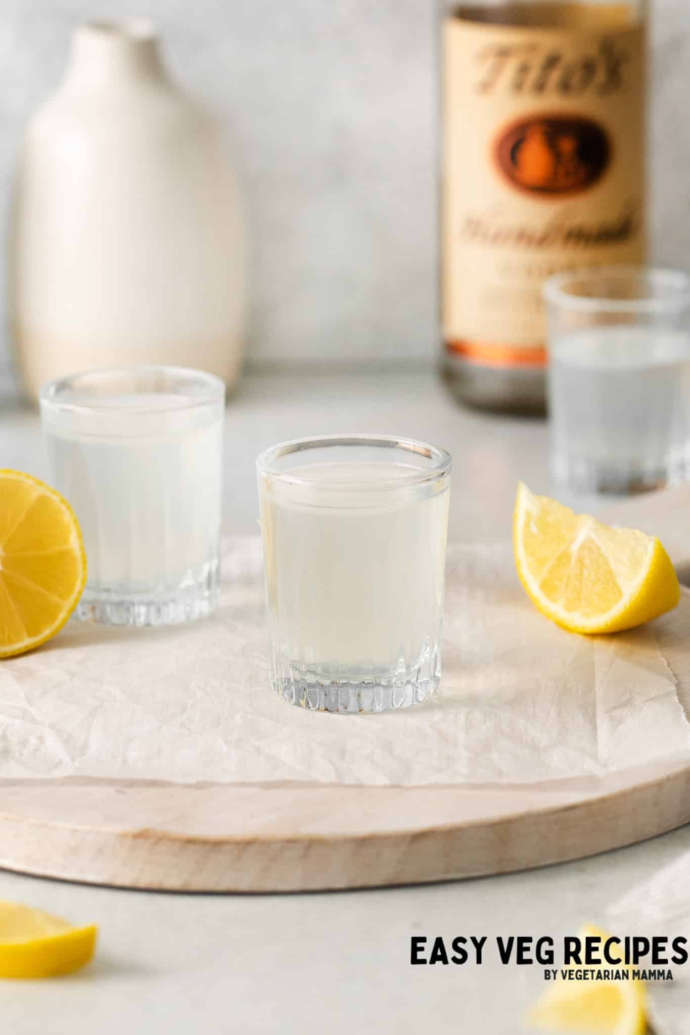 white tea shots with lemon wedges.