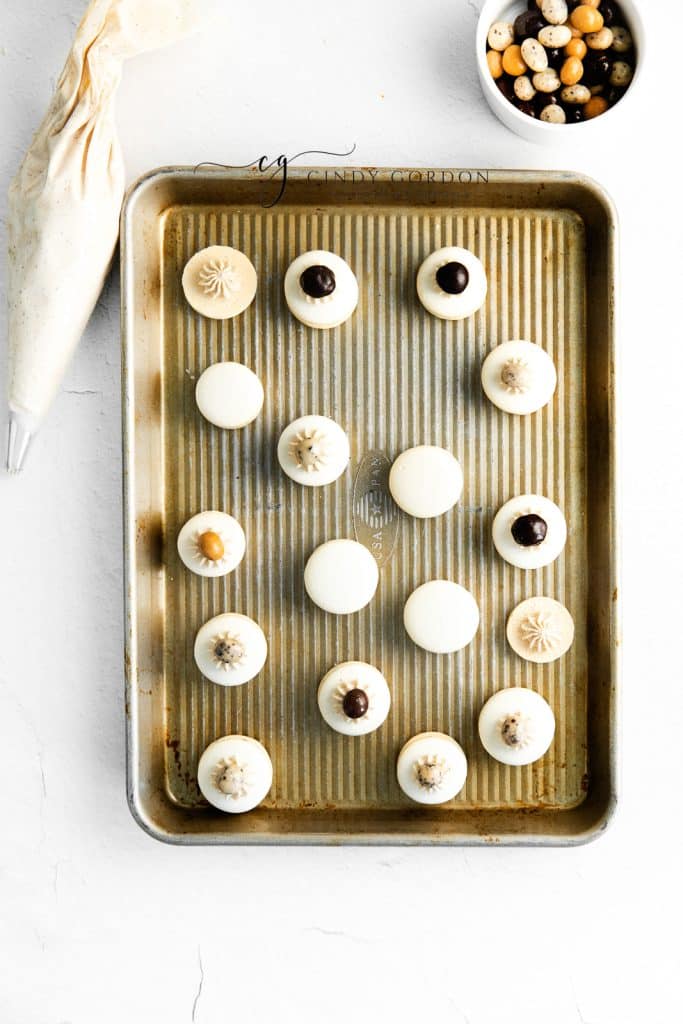 assembled coffee macarons. Some are topped with coffee beans.