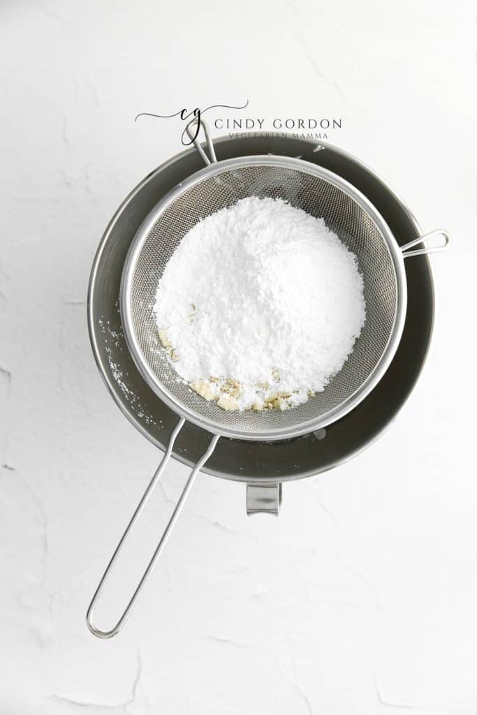 sugar and almond flour sifted into a mixing bowl.