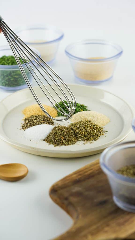 spices in a shallow bowl, being whisked together.