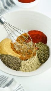 spices in a large bowl, being whisked together.