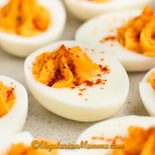 Million dollar deviled eggs with paprika garnish.