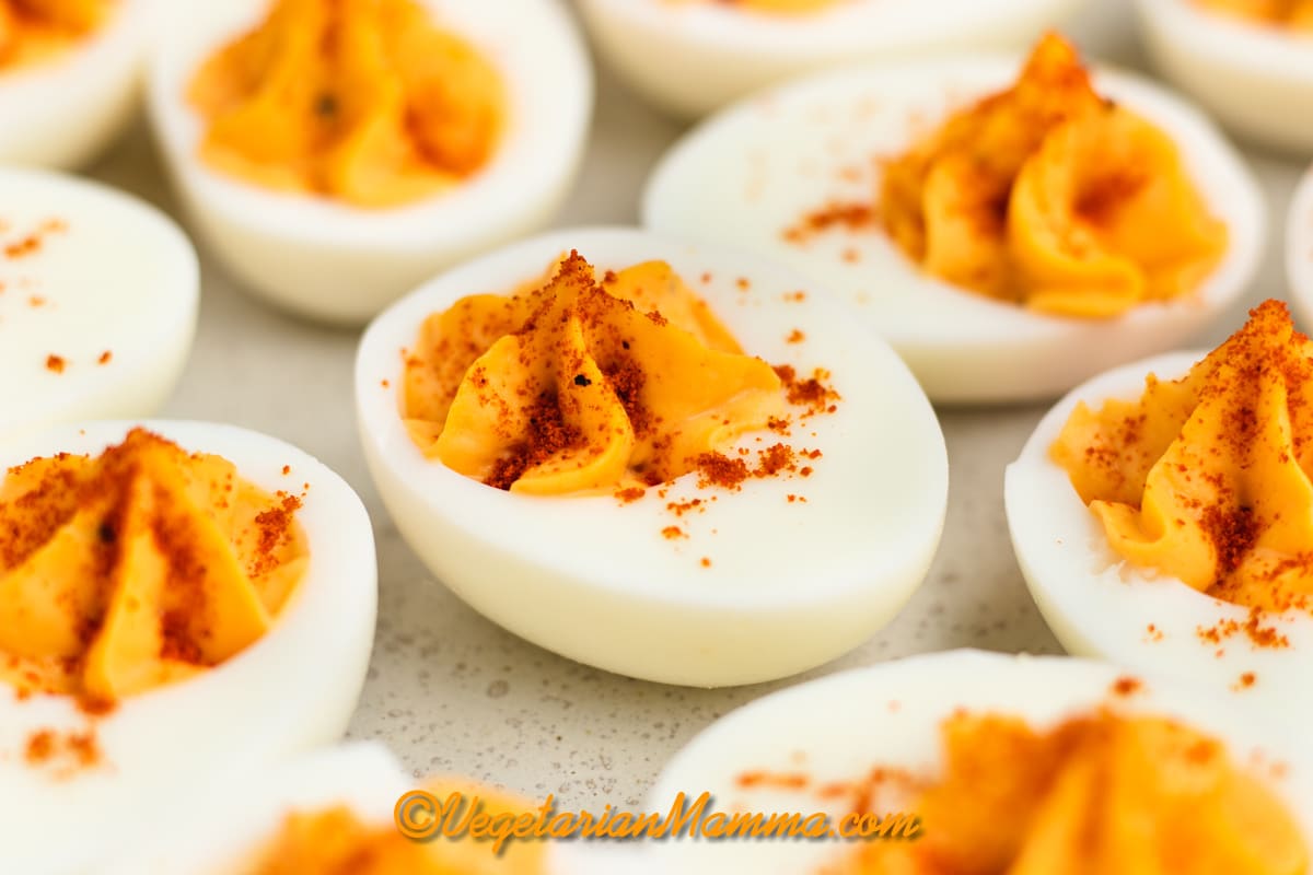 Million dollar deviled eggs with paprika garnish.