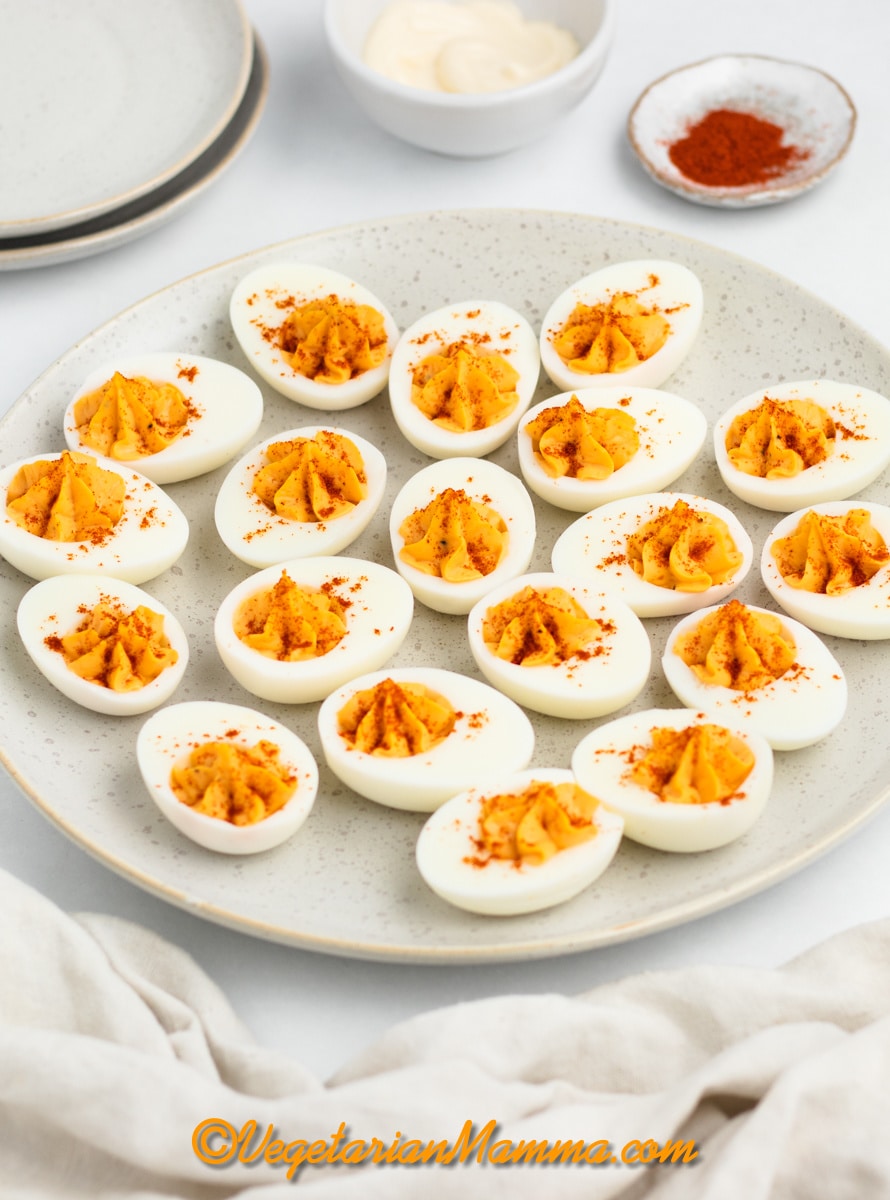 a round plate filled with million dollar deviled eggs