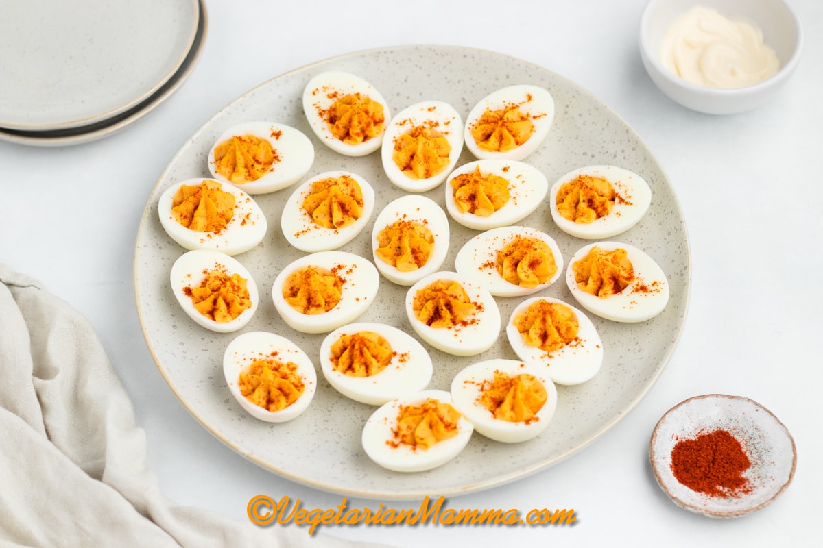 a round plate filled with million dollar deviled eggs