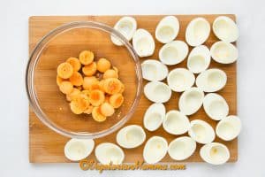 Peel the hard boiled eggs and slice them into halves.
