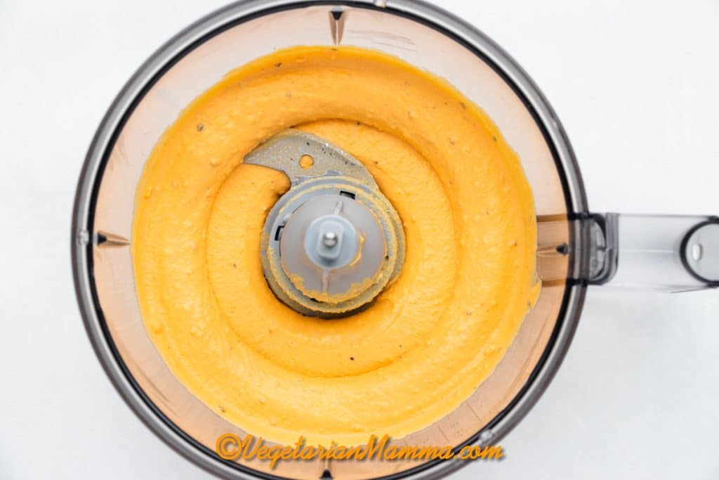 Carefully scoop out the yolks into a bowl and place into food processor with ingredients.