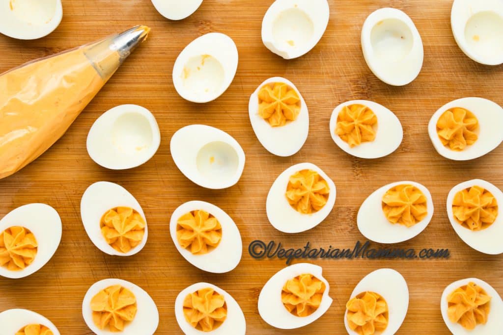 Transfer the yolk mixture to a piping bag and pipe swirls back into the hollows of the egg whites. Garnish with a sprinkle of paprika if desired.