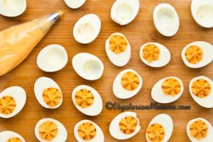 Transfer the yolk mixture to a piping bag and pipe swirls back into the hollows of the egg whites. Garnish with a sprinkle of paprika if desired.