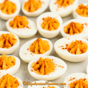 million dollar deviled eggs with star piped filling and paprika sprinkle.
