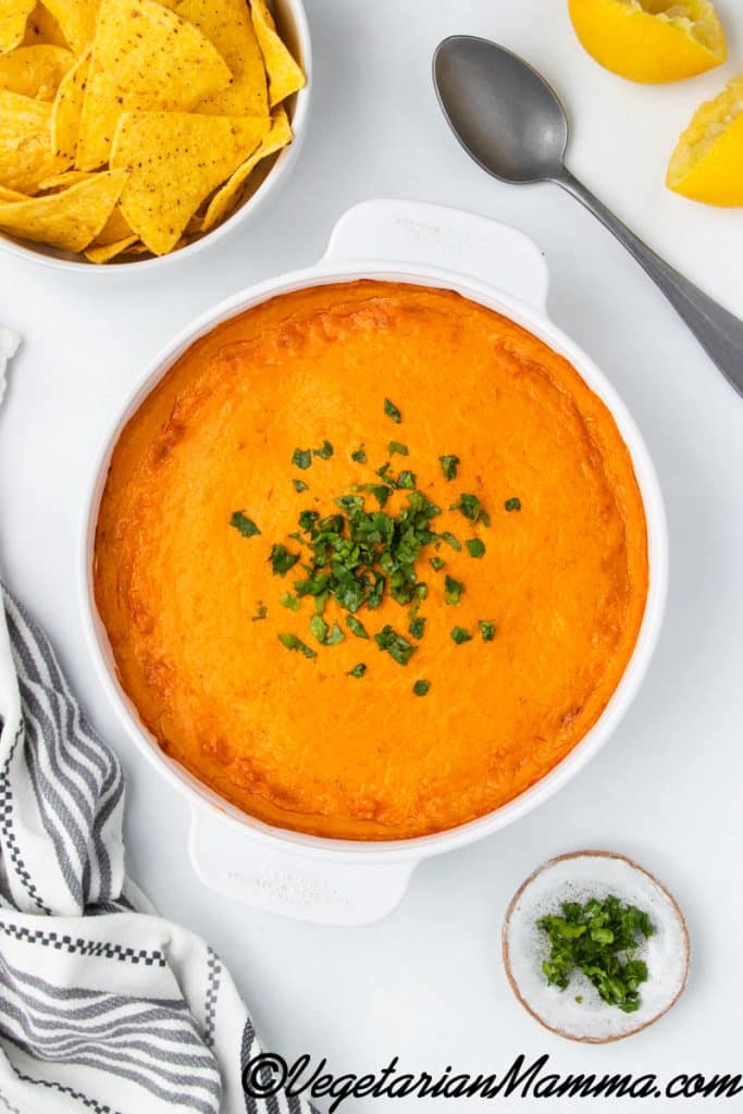 Vegan buffalo chicken dip ready to serve by placing some fresh cilantro on top.