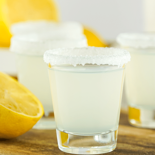a sugared rim shot glass filled with vodka and lemon juice to make a lemon juice shot