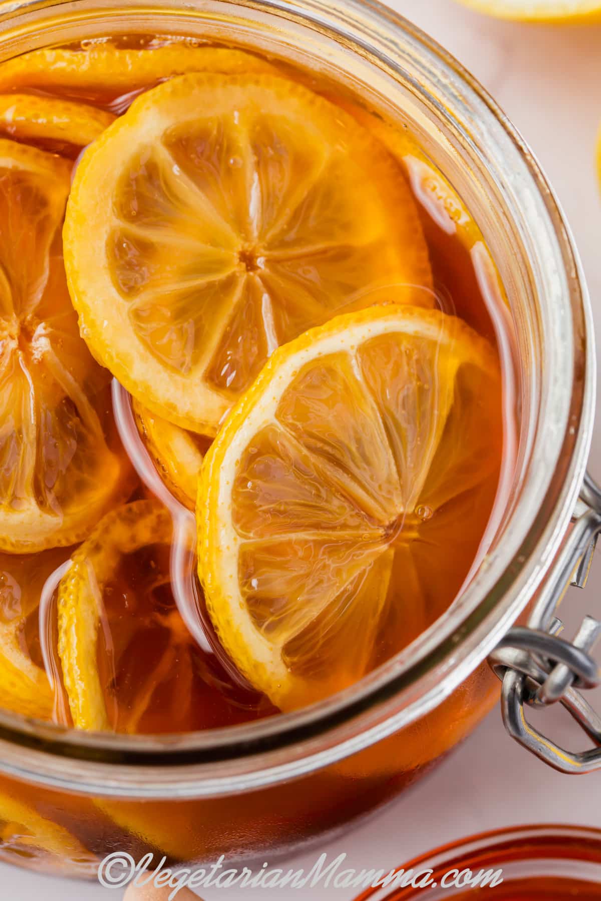 glass jar filled with lemons and honey