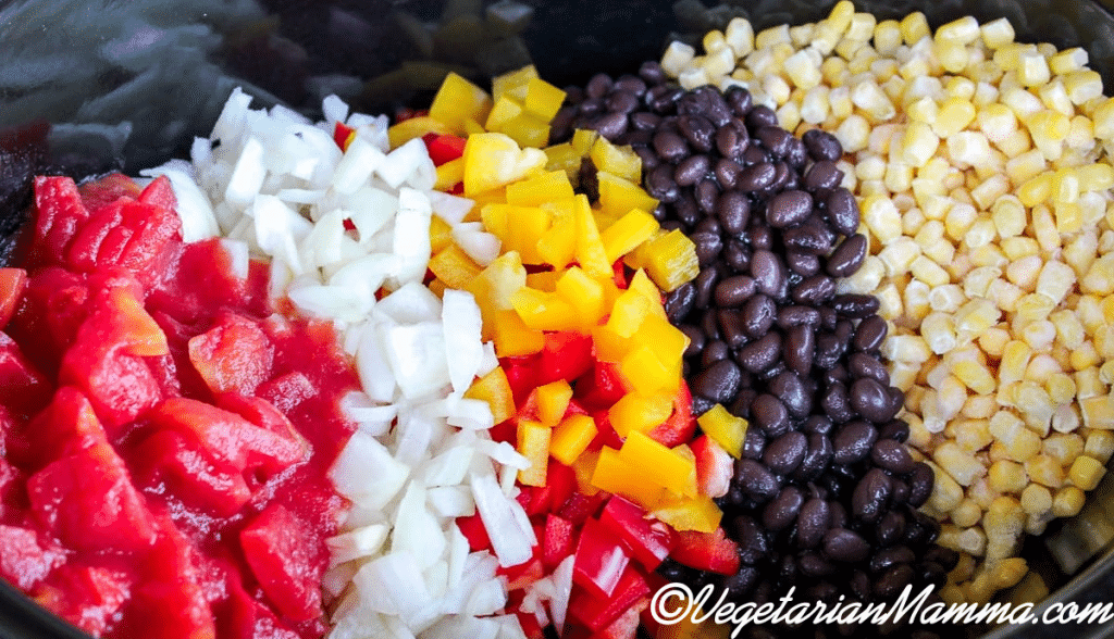 A perfect array of diced tomatoes, onions, yellow bell pepper, black beans, and corn