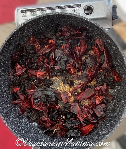 Chilies and cumin seeds in skillet.