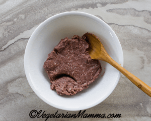 A white bowl with Beyond Meat and a wooden spoon.