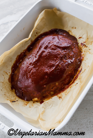 Using a spoon or brush, add the glaze to the loaf.