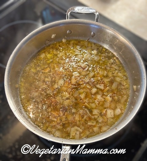 onions sauteing in a skillet