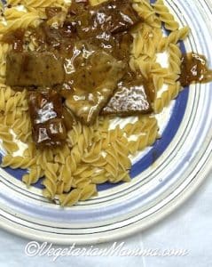 plate of beef stroganoff on top of pasta