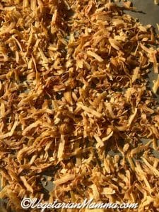 toasted coconut shreds on a baking sheet.