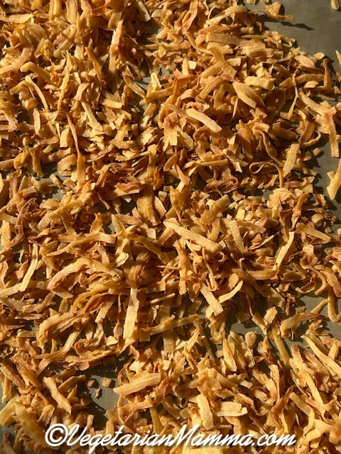 toasted coconut shreds on a baking sheet.