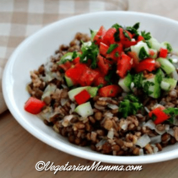 A white bowl of Mujadara with lentils and rice.