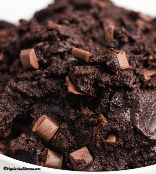 closeup image of edible brownie batter with chocolate chunks
