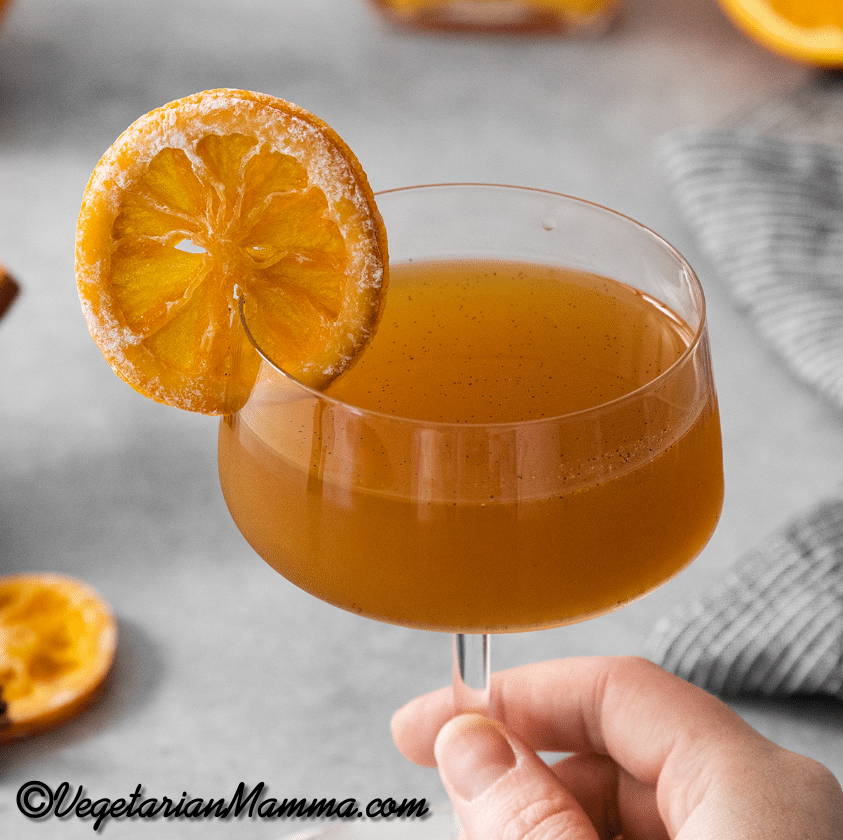Close up of a glass filled with winter orange whiskey cocktail