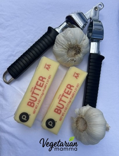 2 sticks butter, 2 garlic bulbs, and a garlic press