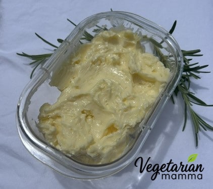 A container of garlic butter ready for use or storage.