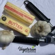 2 sticks butter, 2 garlic bulbs, and a garlic press
