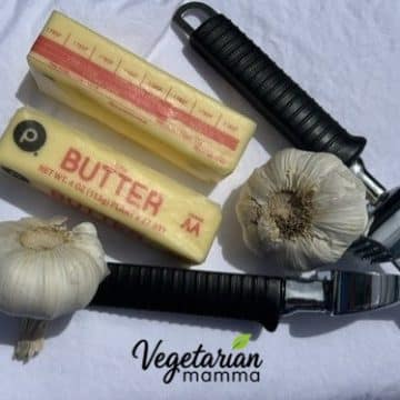 2 sticks butter, 2 garlic bulbs, and a garlic press