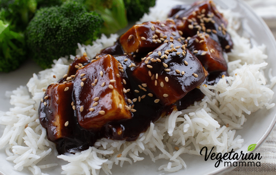 General tso tofu on a bead of white rice.