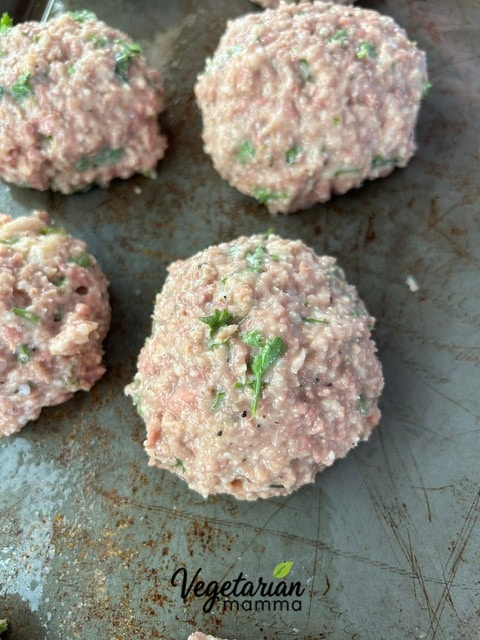 A sheet pan of Impossible Italian Meatballs ready for the oven. 